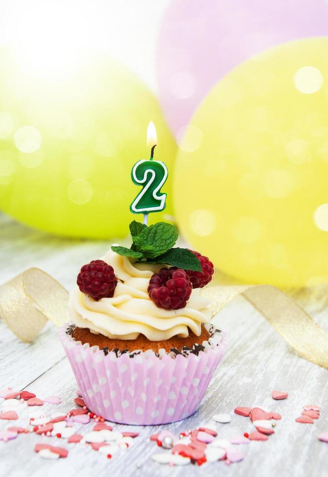 Cupcake with a numeral two candle photo