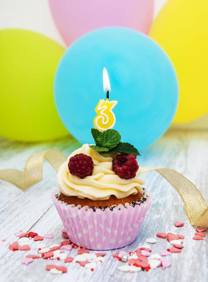 Cupcake with a numeral three candle photo