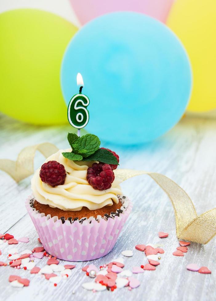 Cupcake with a numeral six candle photo