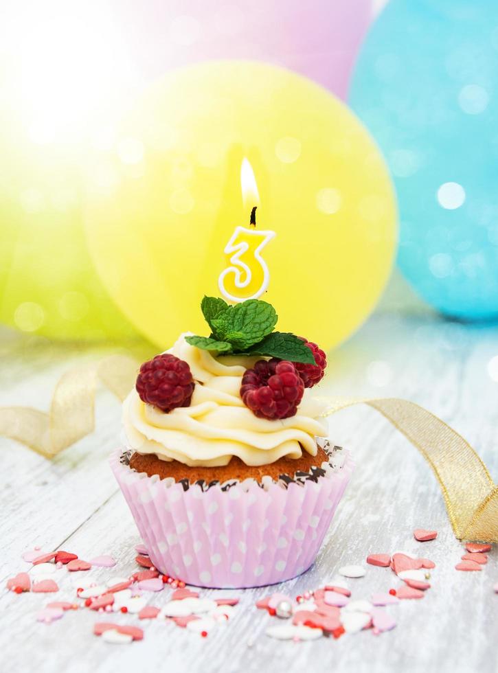 Cupcake with a numeral three candle photo