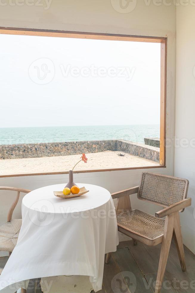 beautiful and empty minimal table and chair on side window photo