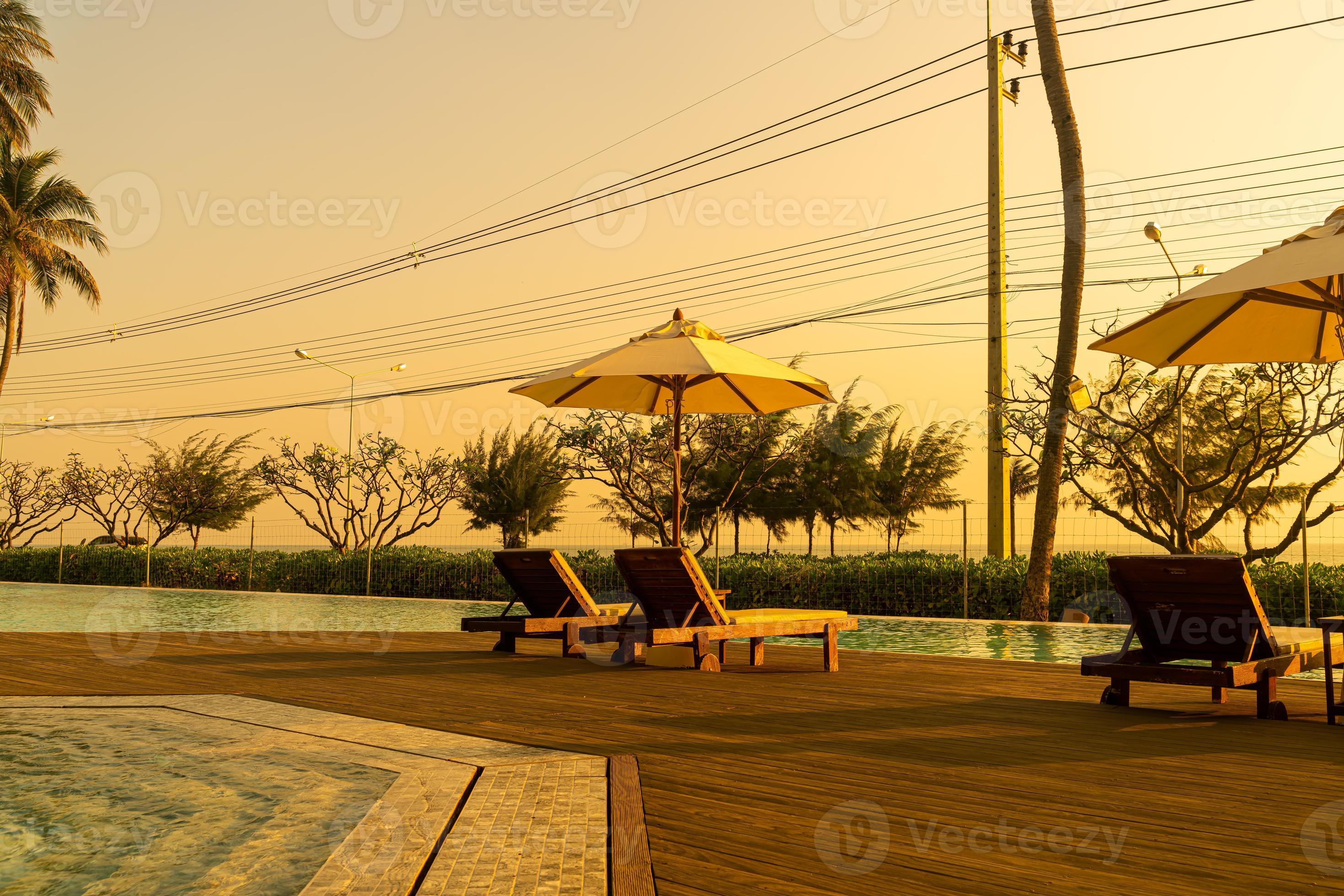 umbrella with bed pool around swimming pool with ocean sea background