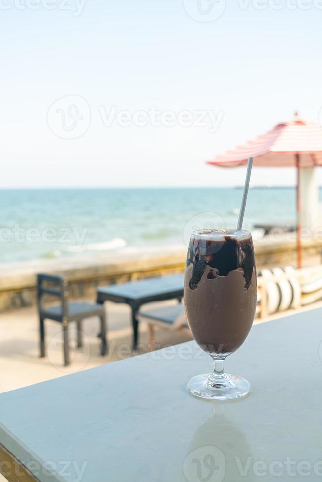 ice chocolate milkshake with sea background photo