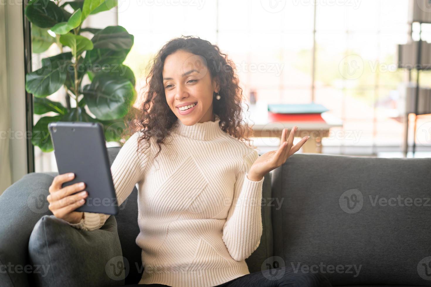 Latin woman video conference on tablet with happy feeling photo