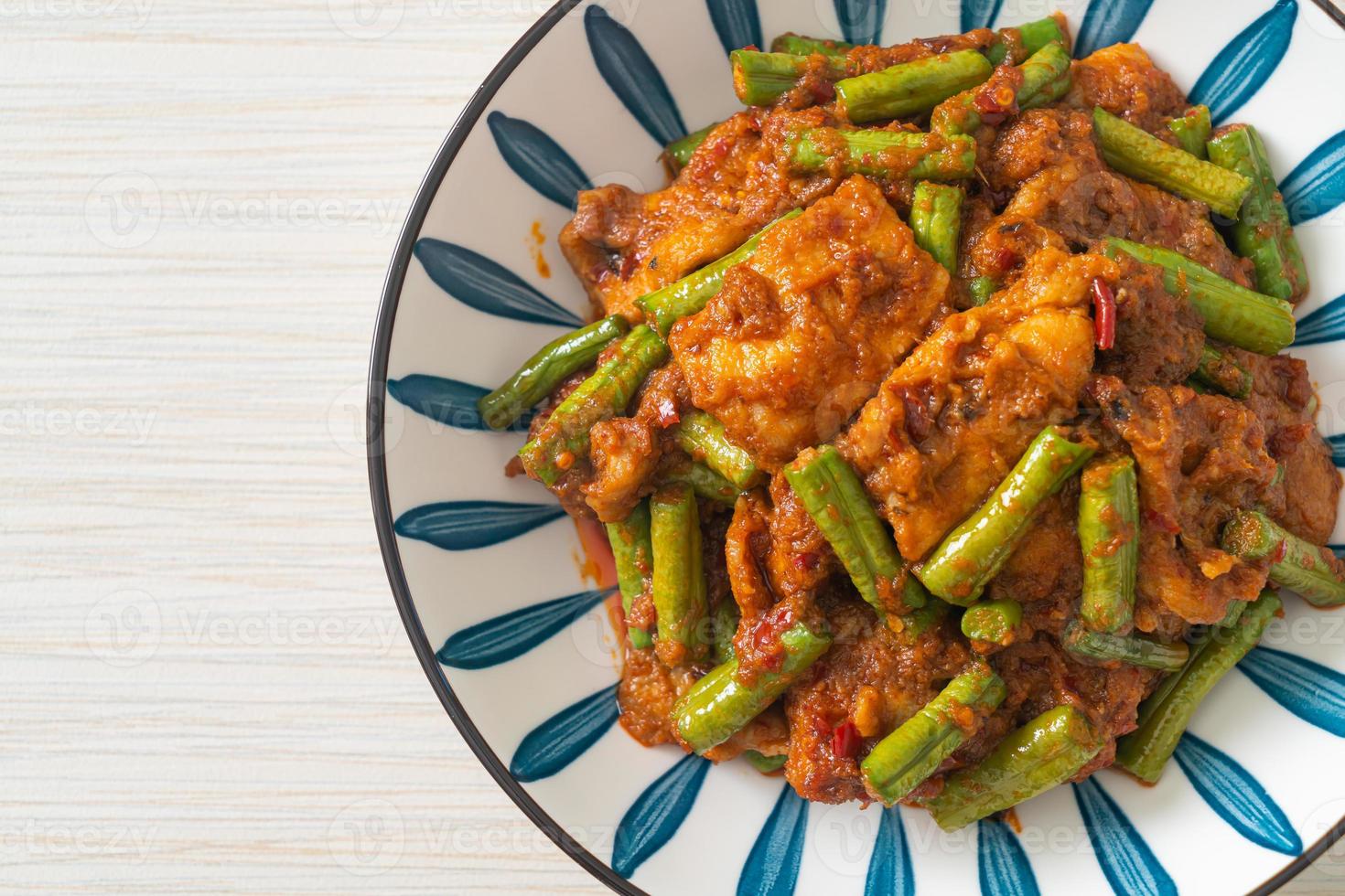 Stir fried pork with red curry paste photo