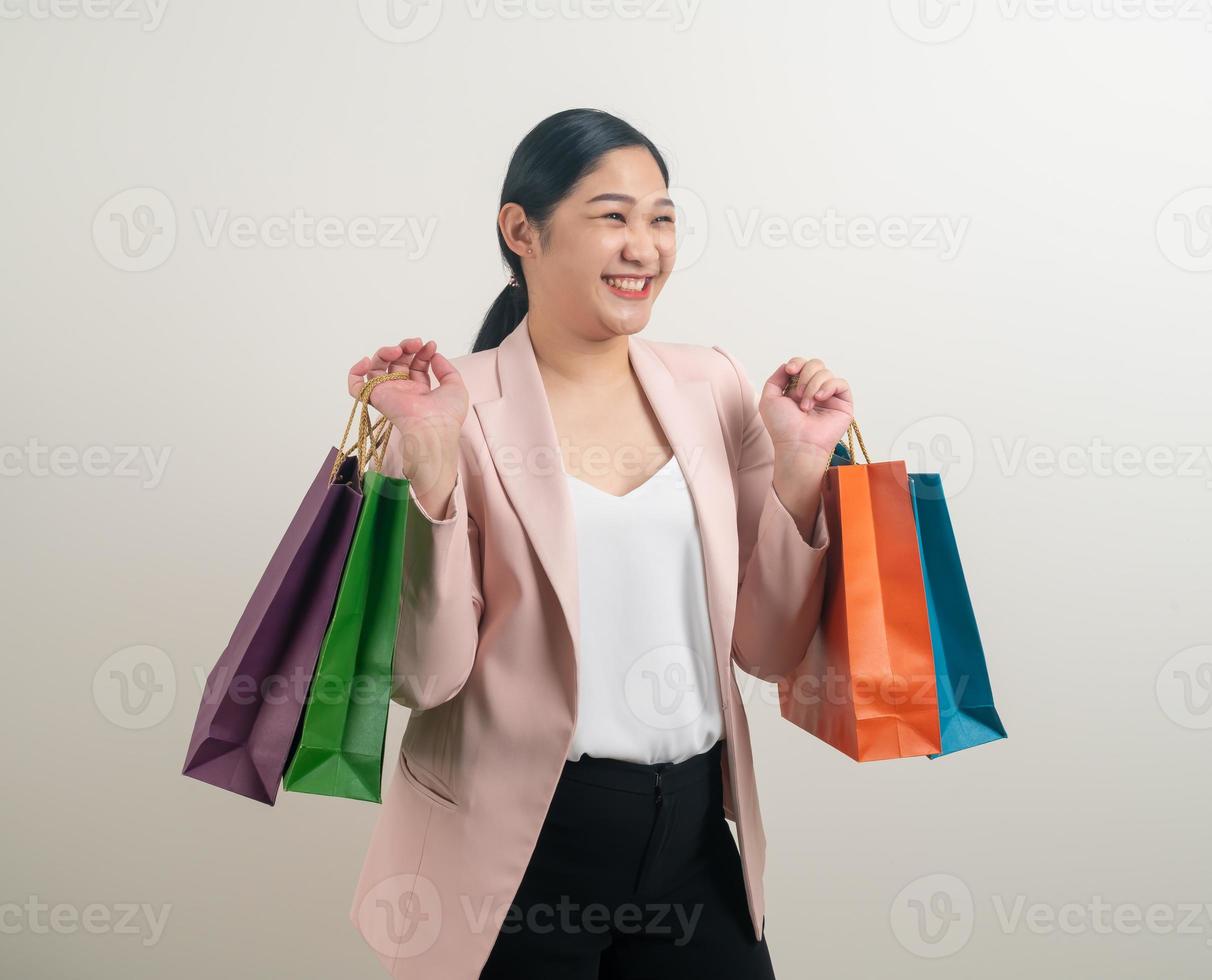 Asian woman holding shopping bag on hand photo