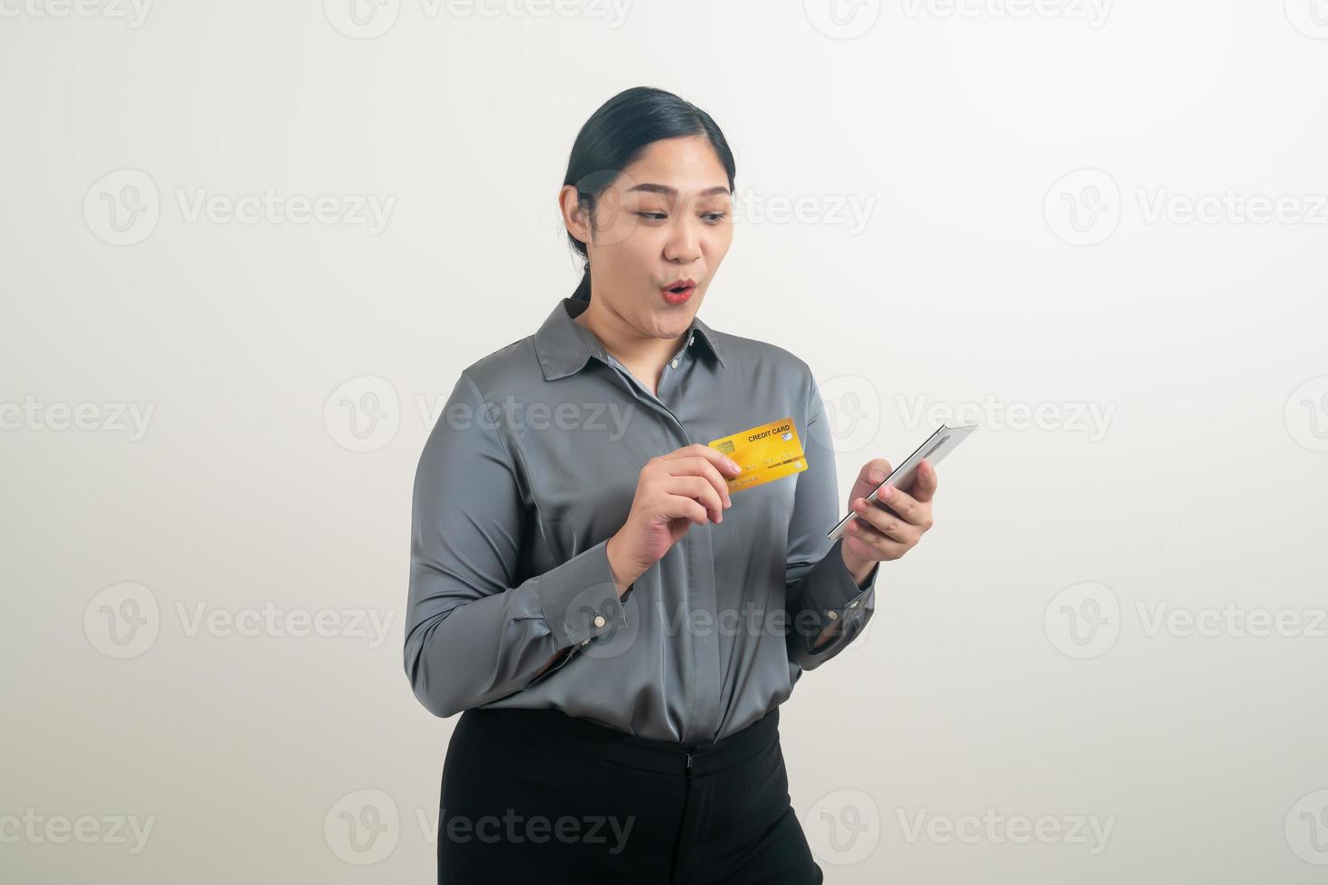 Asian woman using smartphone with hand holding credit card photo