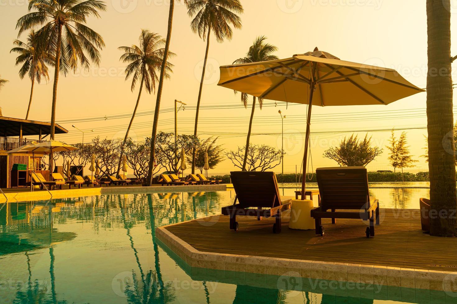umbrella with bed pool around swimming pool with ocean sea background