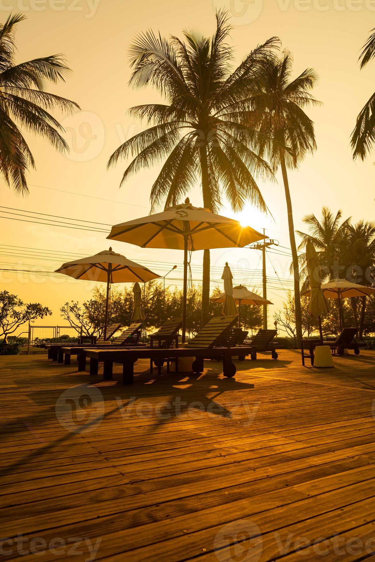 umbrella with bed pool around swimming pool with ocean sea background