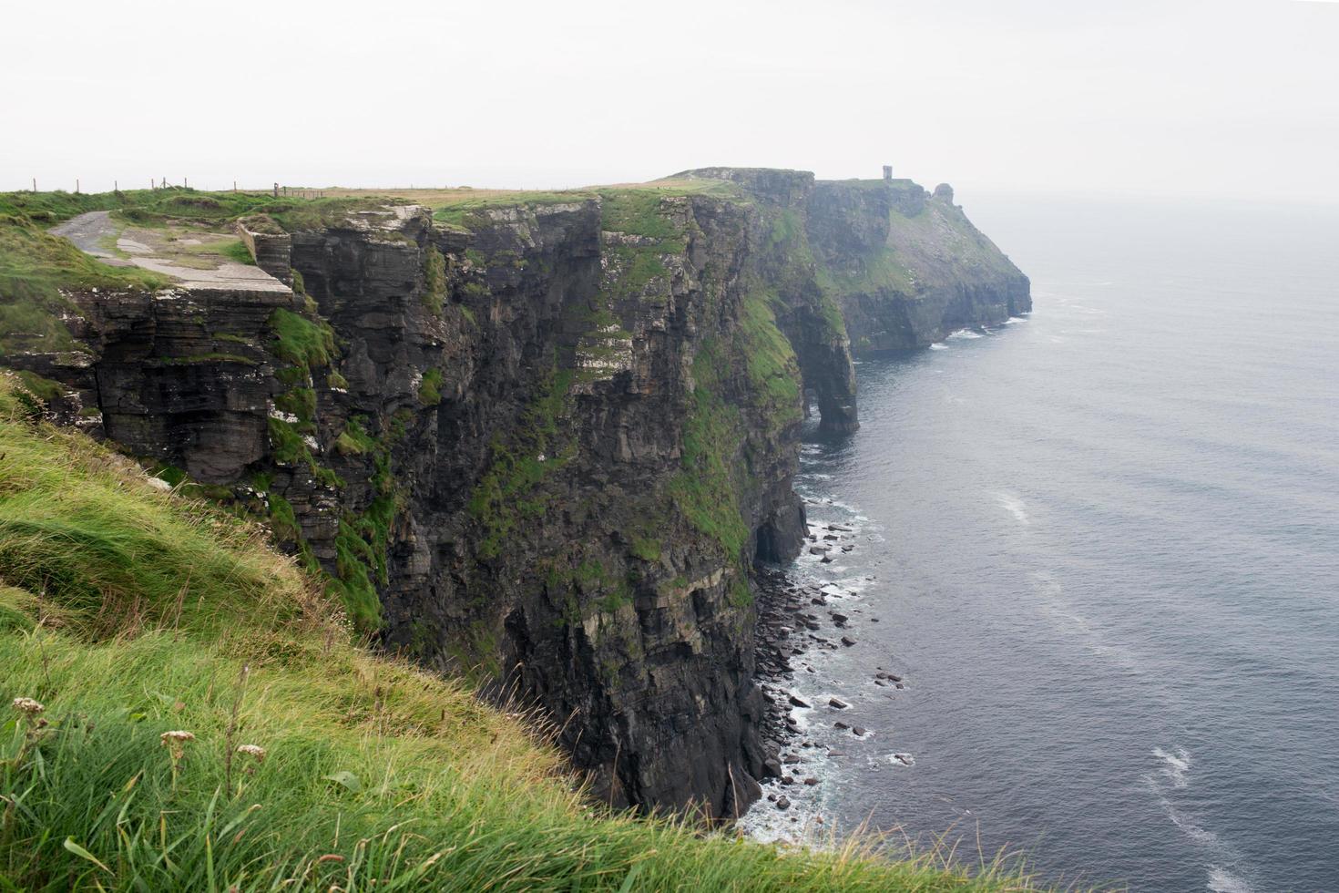 Beautiful cliffs at Moher on a rainy day. Calm water. Ireland photo
