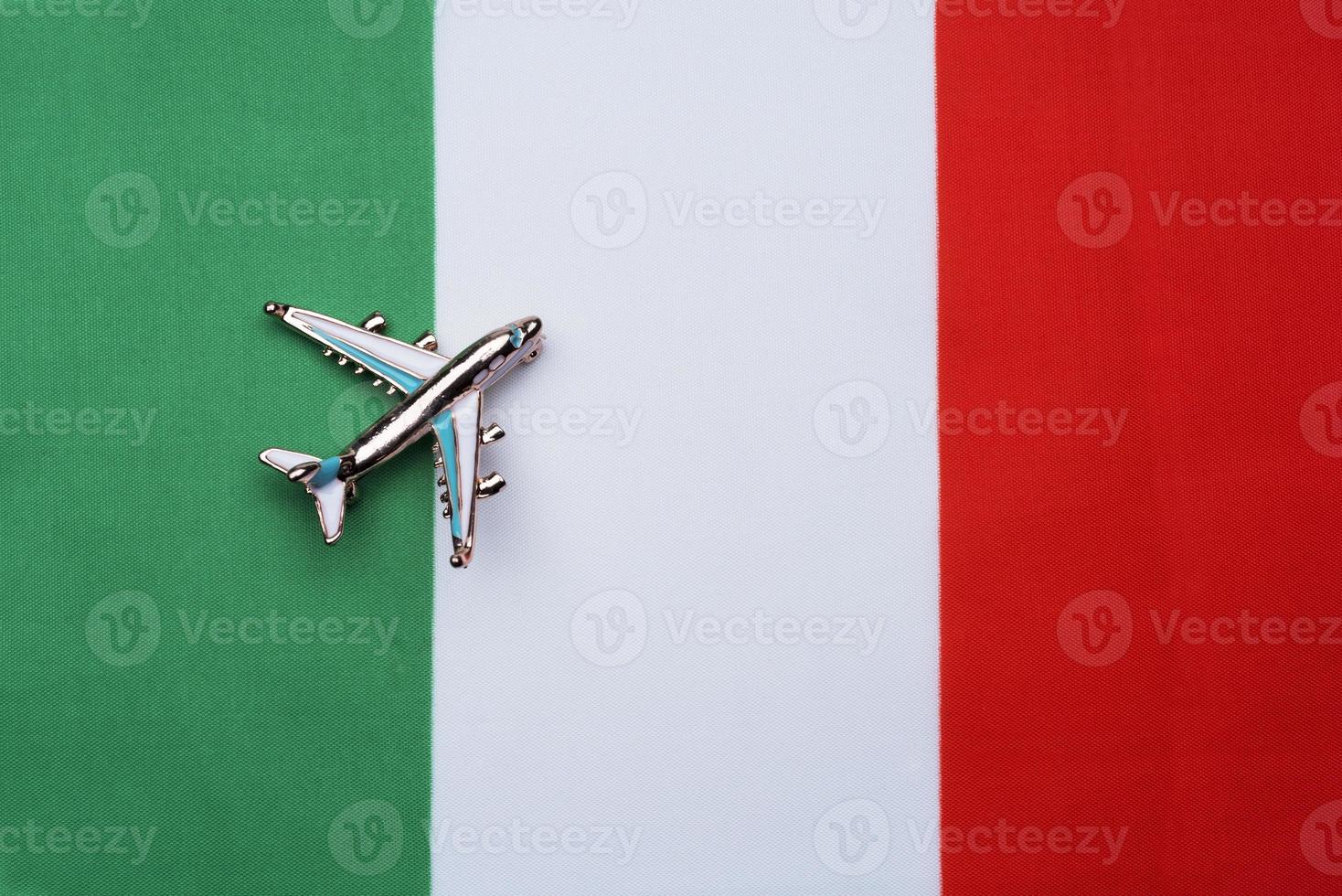 Flag of Italy and the plane. The concept of travel. photo