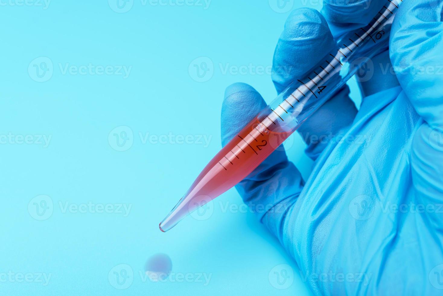 Hands of clinician holding tools during scientific experiment in laboratory photo