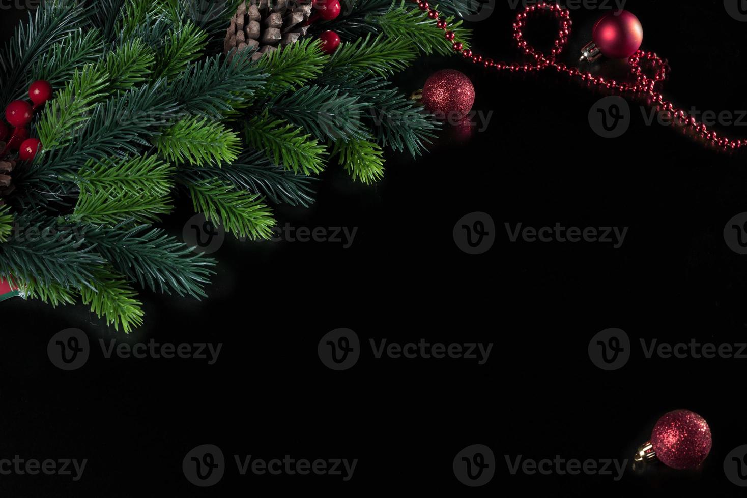 christmas black background with spruce branch and christmas tree toy ball photo