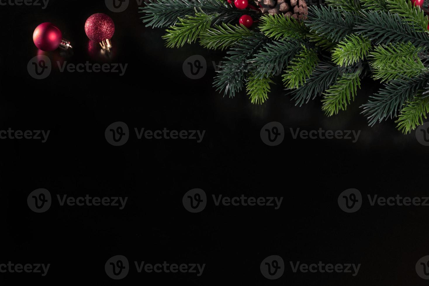 christmas black background with spruce branch and christmas tree toy ball photo