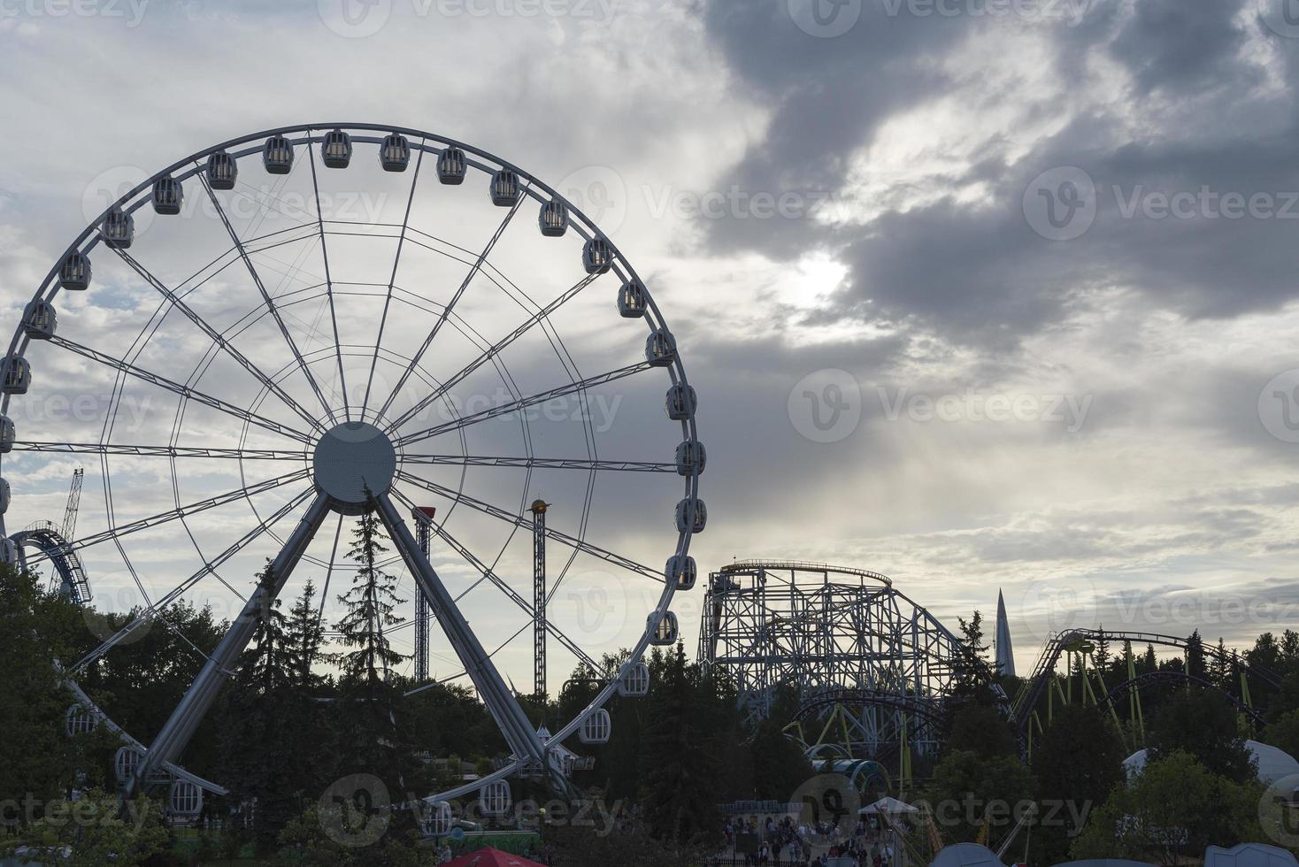 Big Ferris Wheel on clear blue sky background, close up photo