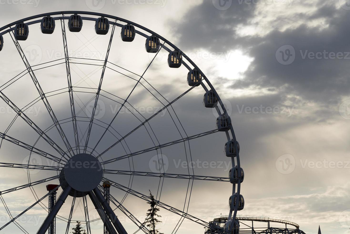 Big Ferris Wheel on clear blue sky background, close up photo
