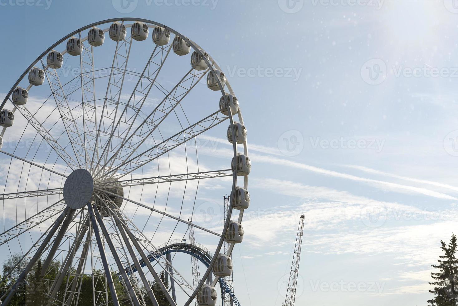 Big Ferris Wheel on clear blue sky background, close up photo