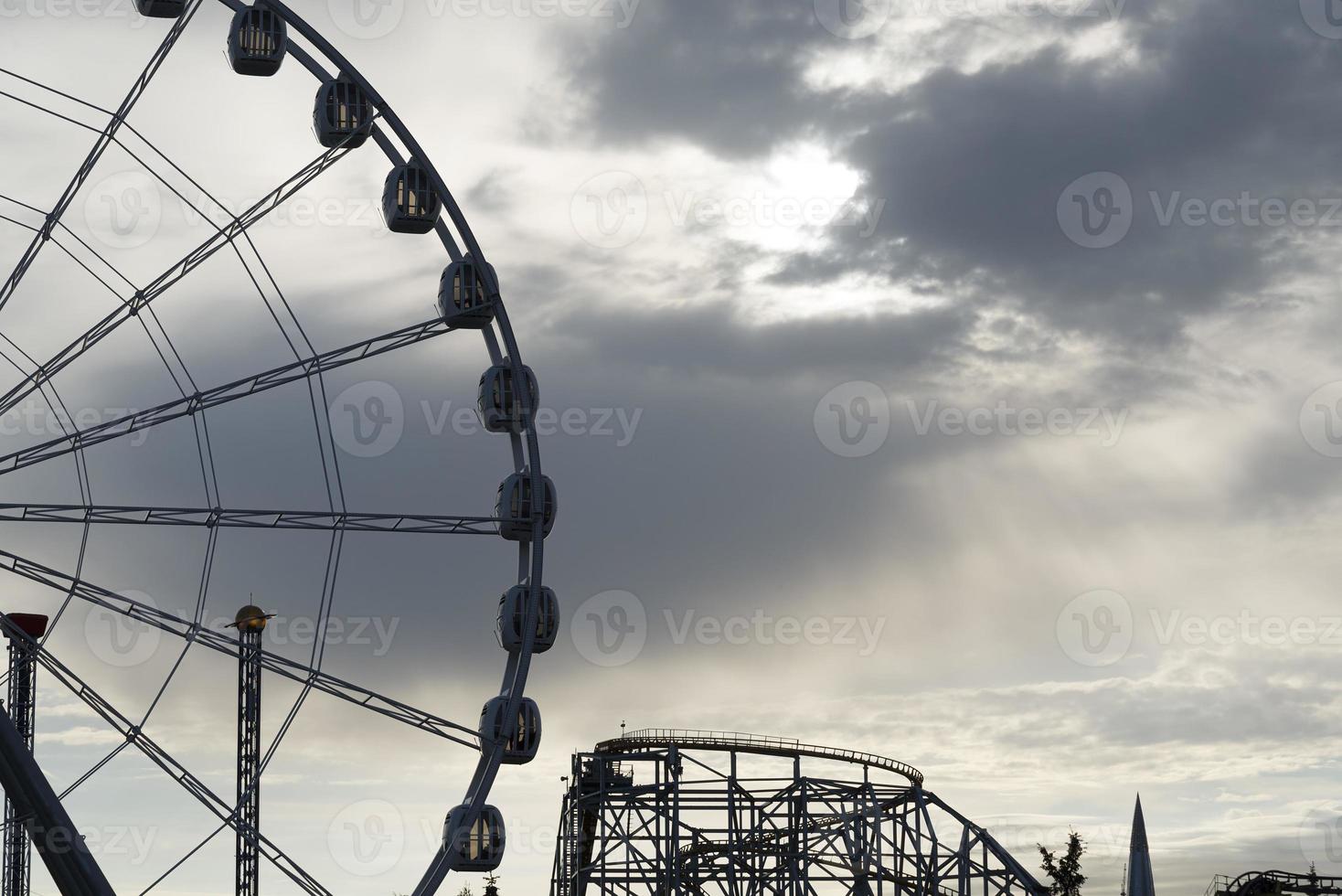 Big Ferris Wheel on clear blue sky background, close up photo