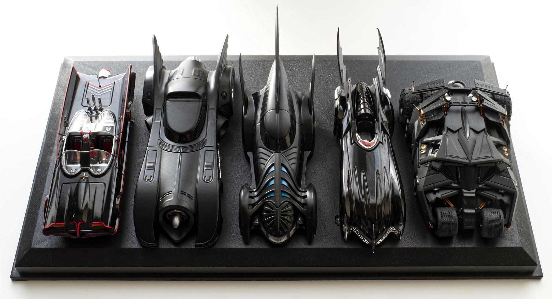 Bologna,Italy,2022 Set of five Batmobile from Batman movies on black display. photo