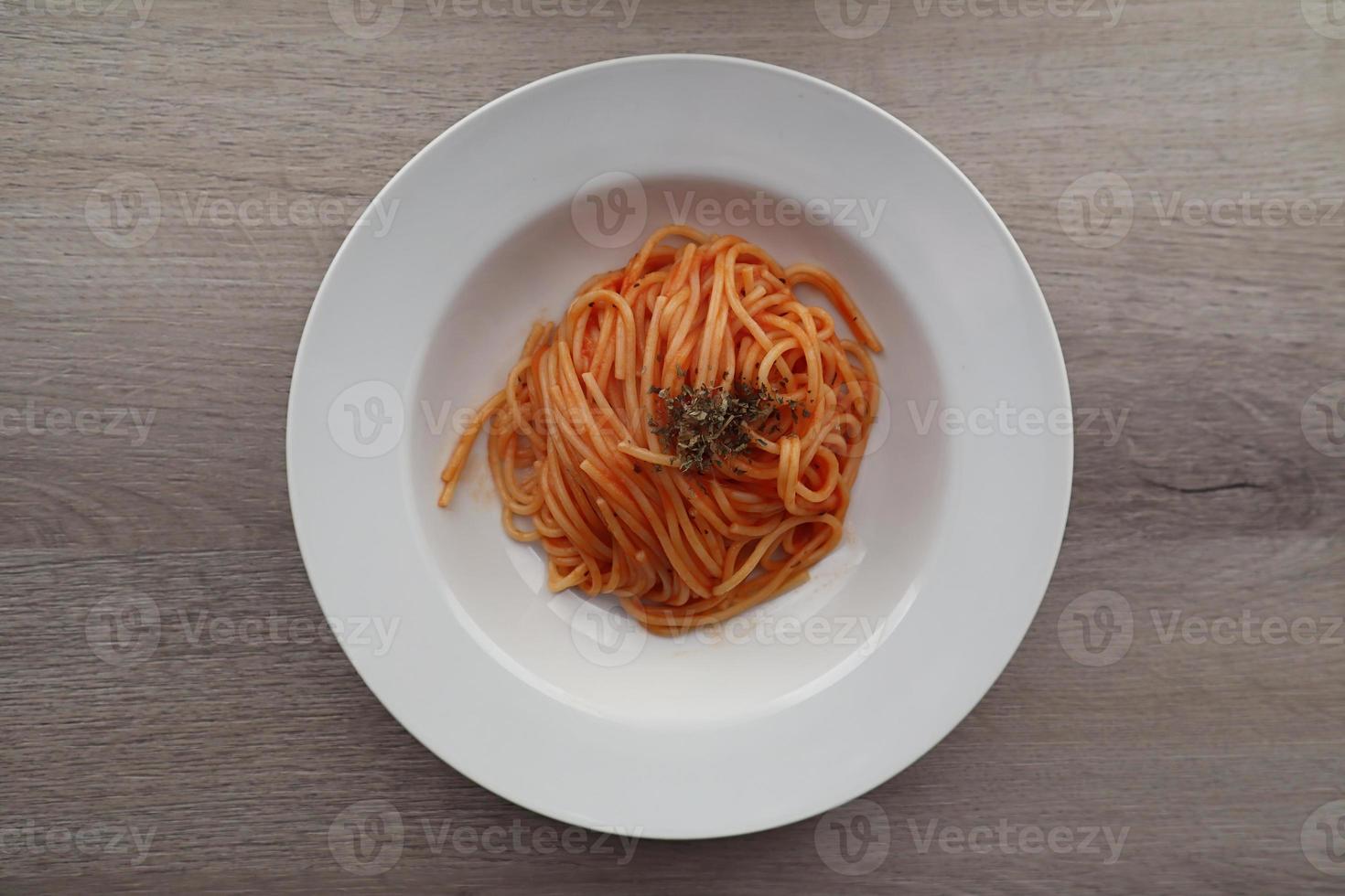 Delicious Italian Spaghetti with tomato sauce on wooden background. View from above. Italy photo