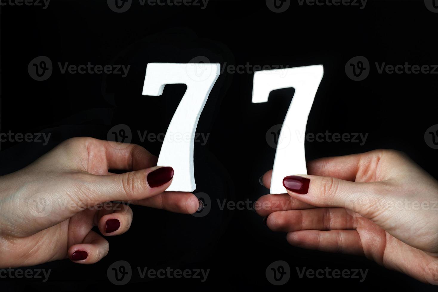 To female hands the figure of seventy-seven. photo