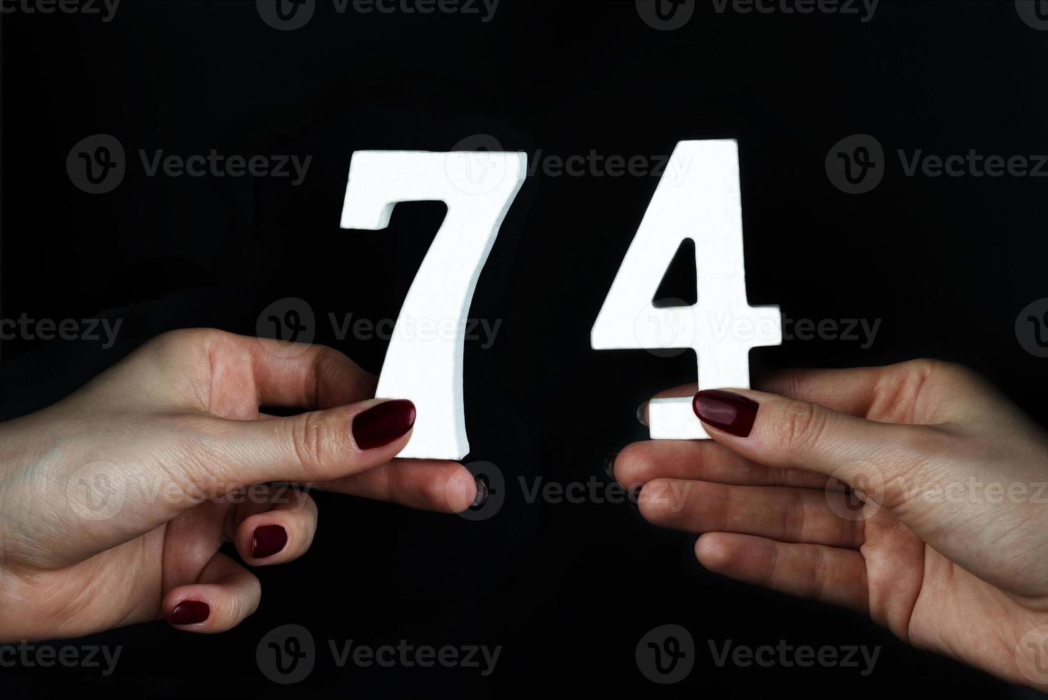 To female hands the figure of seventy-four. photo