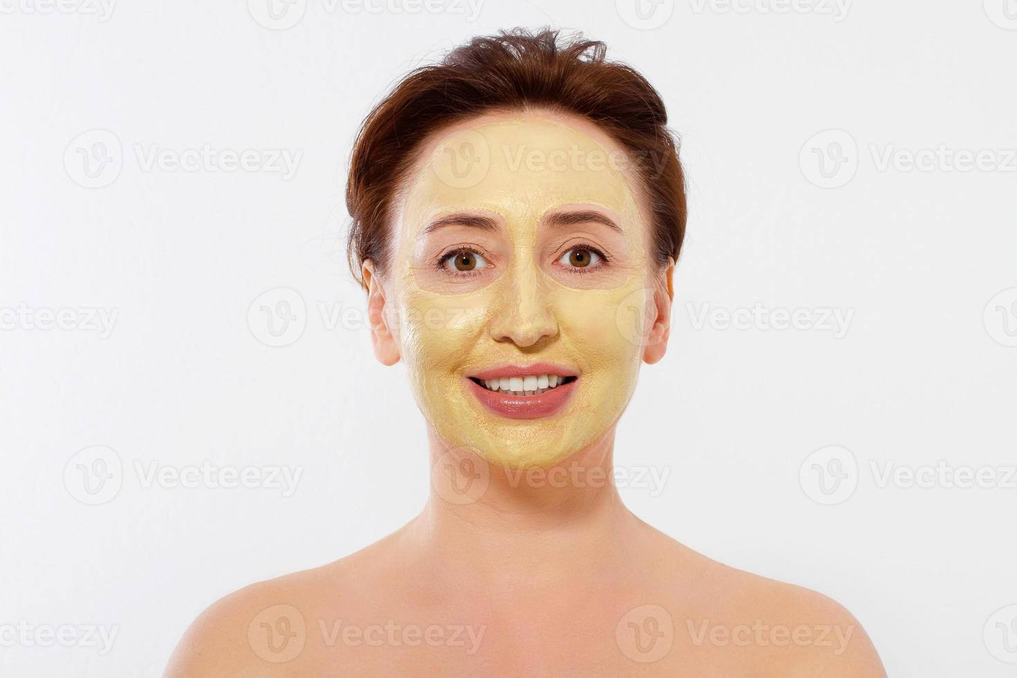 Middle age macro woman face. Summer anti aging collagen mask on woman wrinkle face isolated on white background. Spa and menopause concept. Copy space photo