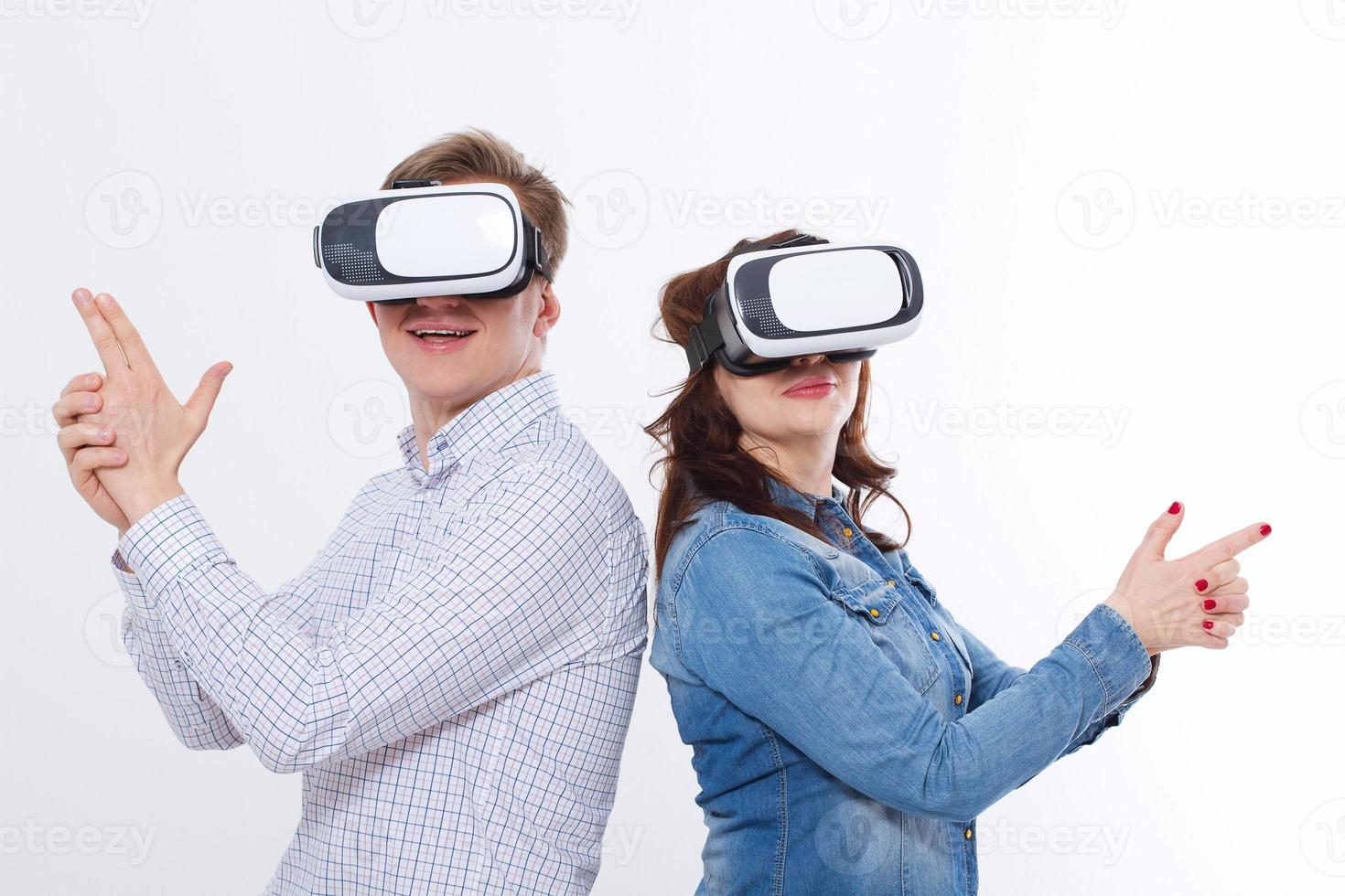 Young man and woman in casual clothes in virtual goggles, vr isolated on white background. Technology and innovation concept. Copy space and mock up. Template photo