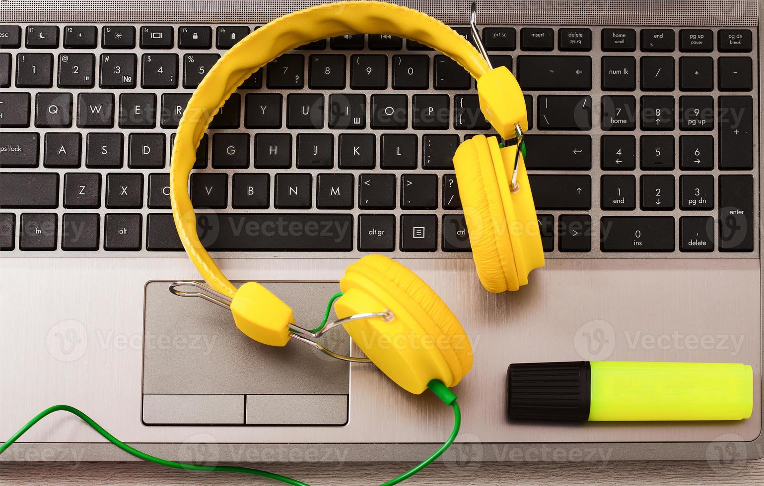 Workplace. Top view. Headphones on laptop computer keyboard communication concept. photo