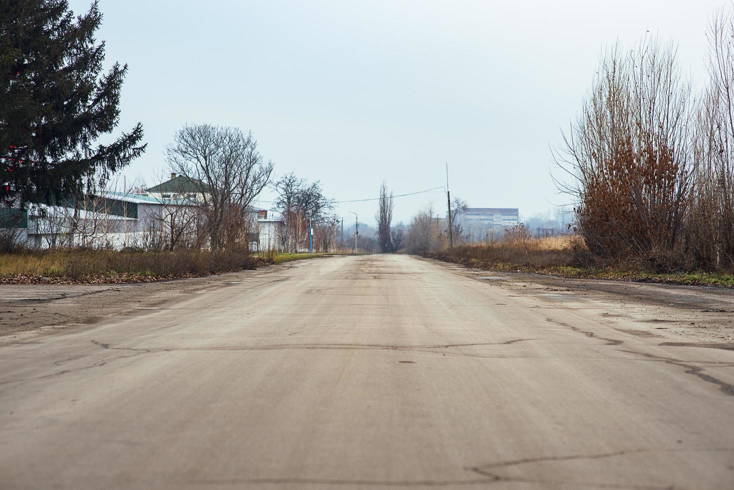 A wide alley or road for cars in foggy, rainy weather, going far. Driving direction for car and pedestrian photo