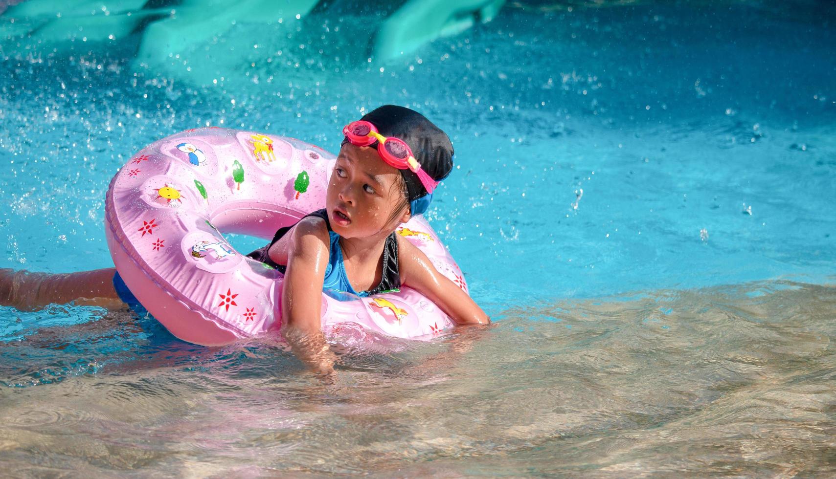 Children frolic at the water park. It is a sunny, perfect day for getting wet and playing hard photo