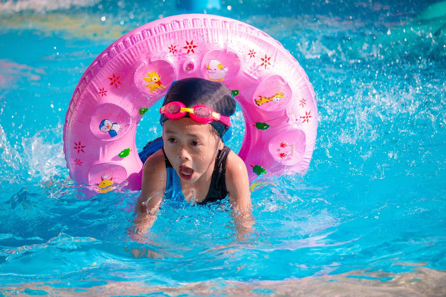 Children frolic at the water park. It is a sunny, perfect day for getting wet and playing hard photo