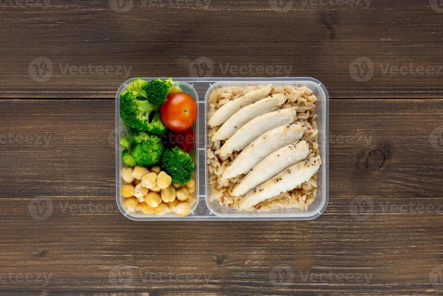 Nutrient dense healthy low fat food in takeaway meal box set on wood background top view photo