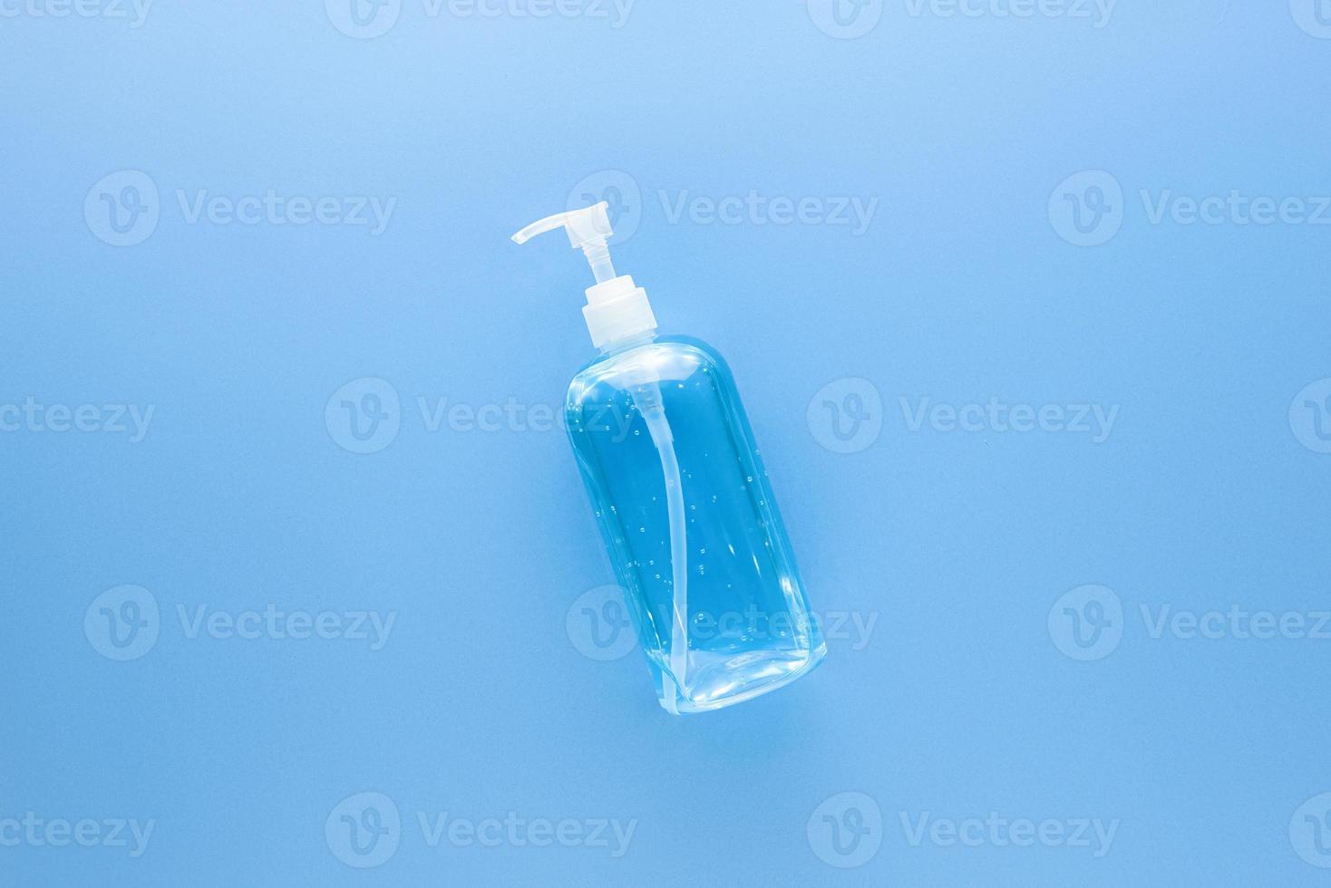 Alcohol hand gel sanitizer in clear pump bottle to protect from germ and Coronavirus on light blue medical background photo