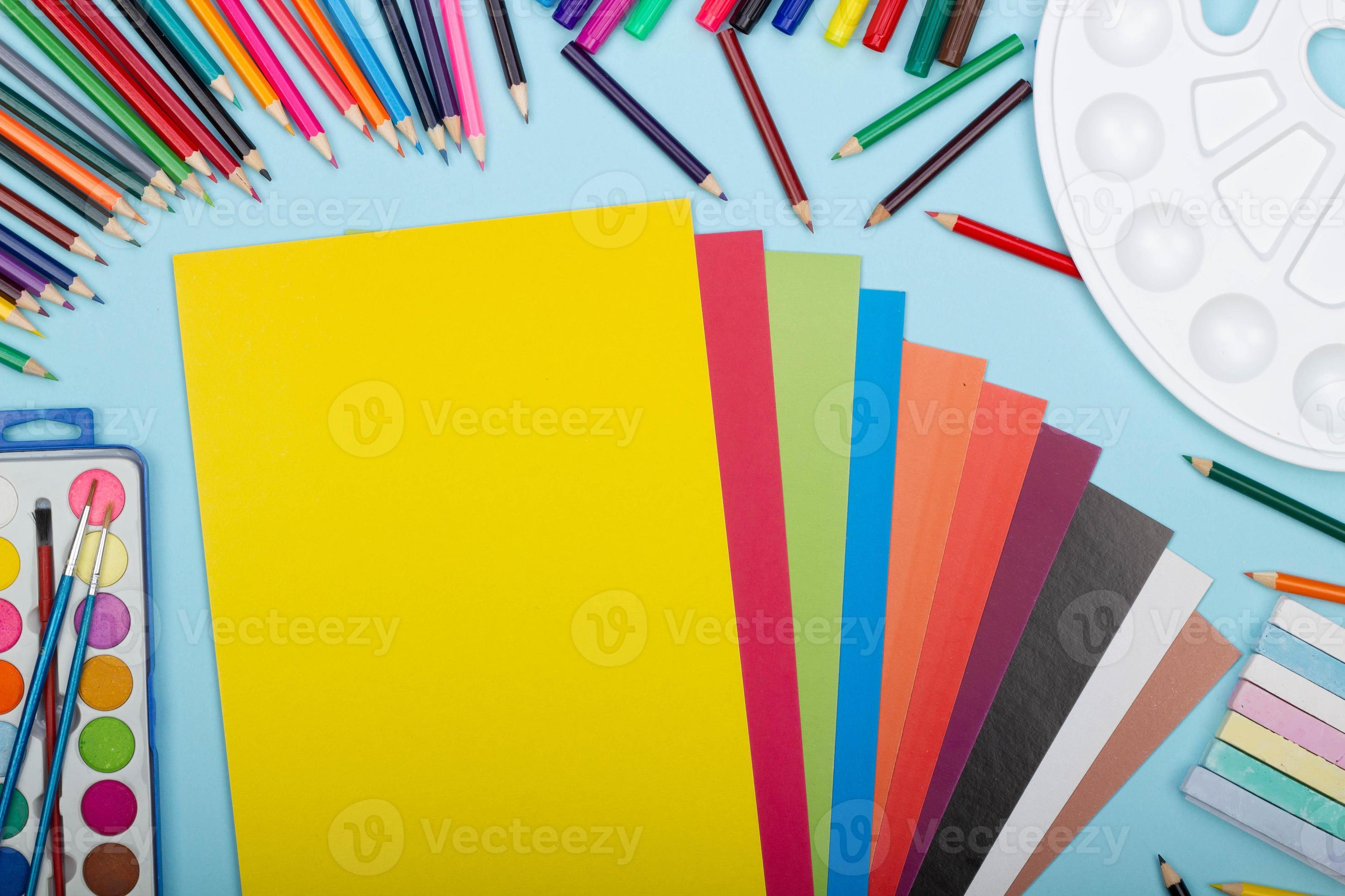 https://static.vecteezy.com/system/resources/previews/005/206/395/large_2x/art-school-supplies-for-painting-and-a-set-of-colored-paper-on-a-blue-background-with-copy-space-for-text-colorful-pencils-markers-paints-crayons-top-view-back-to-school-photo.jpg