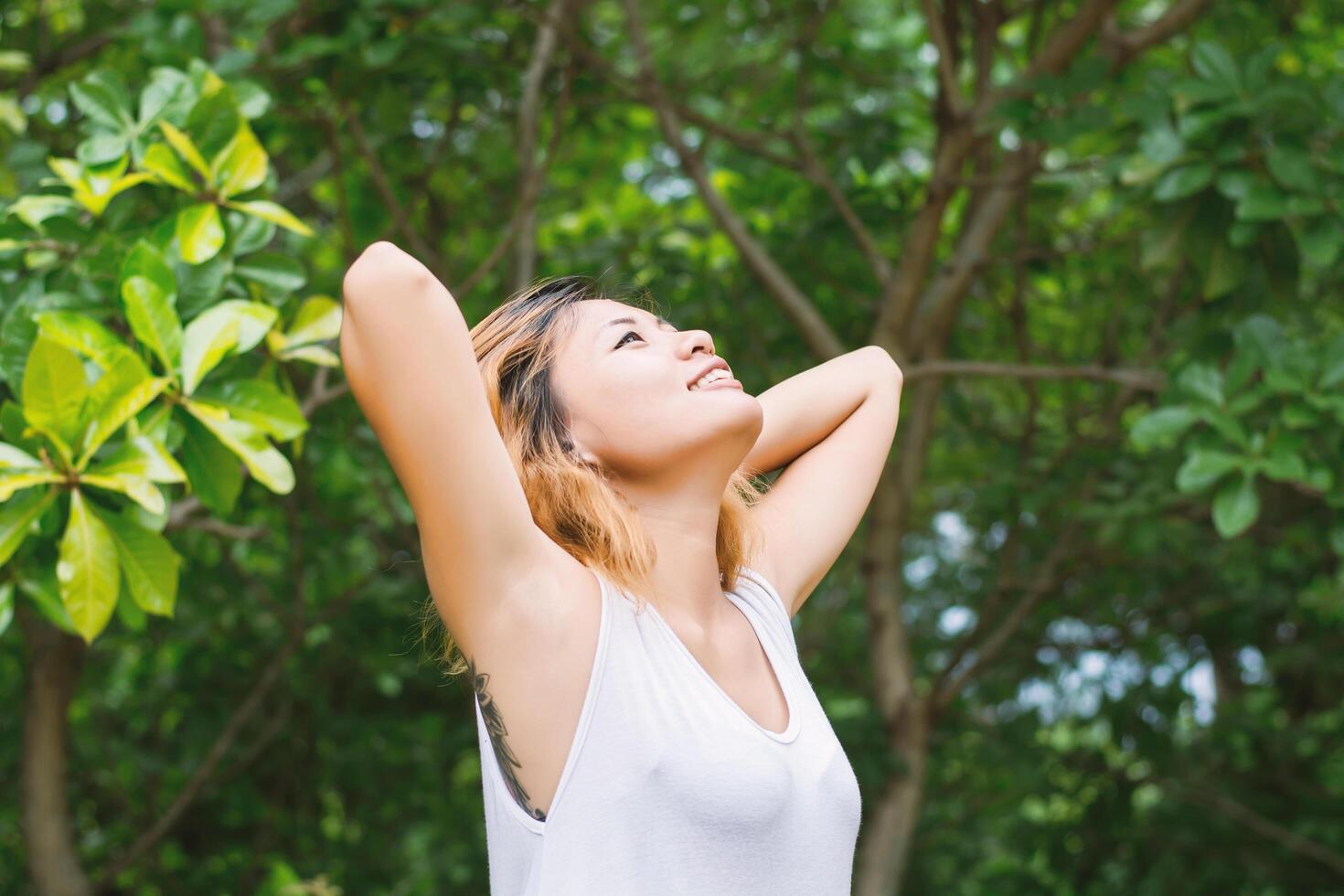 happy woman standing stretch her arms in the air. Enjoy fresh air. photo