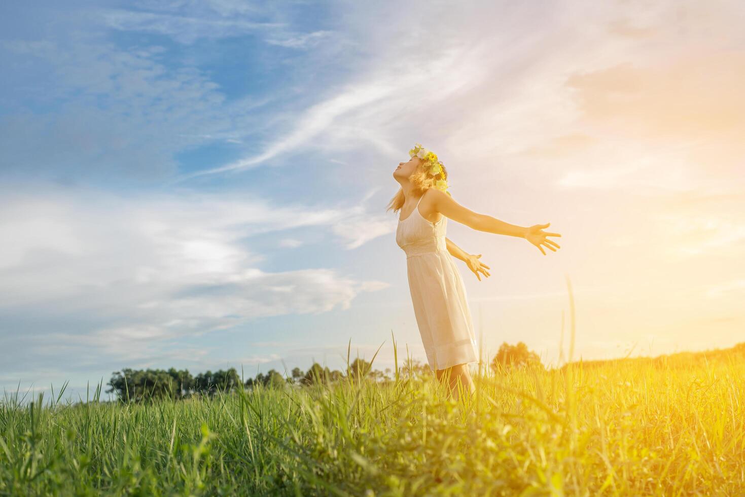 Freedom concept  Young beautiful woman enjoying with fresh air and nature at meadows. photo