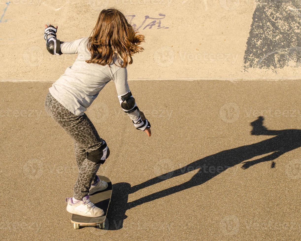 niña montando patineta foto