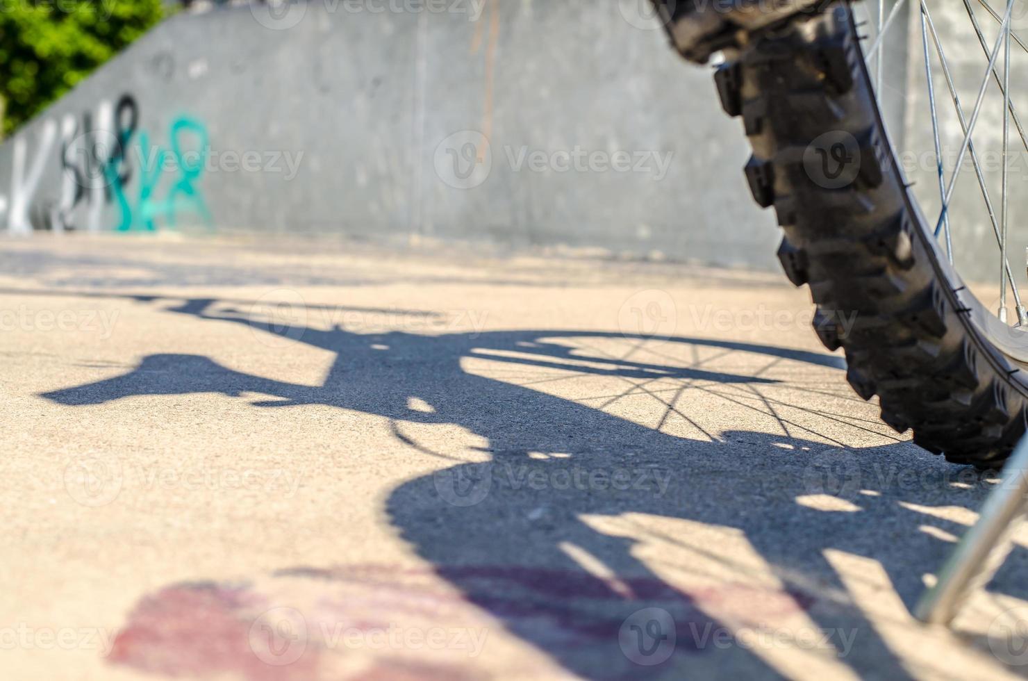 Bicycle wheel shadow on bike park photo