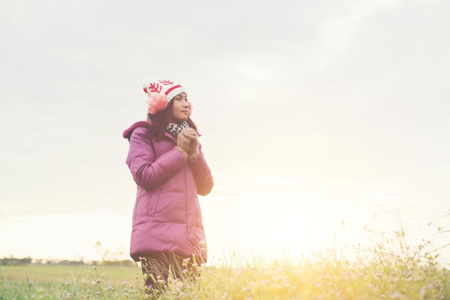 Young woman is happy with the flowers while sunset and winter is coming . Enjoy holiday. photo