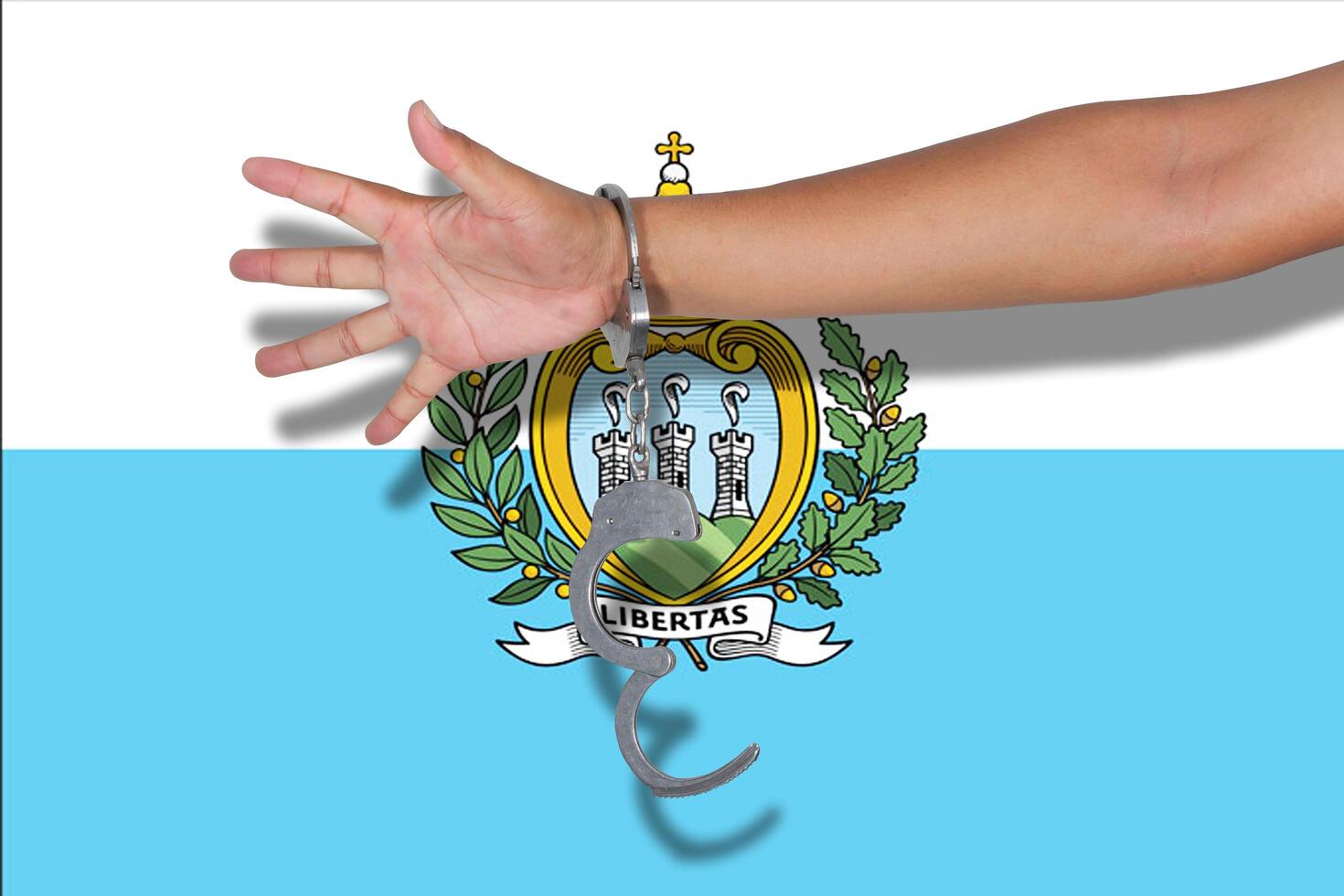handcuffs with hand on San Marino flag photo