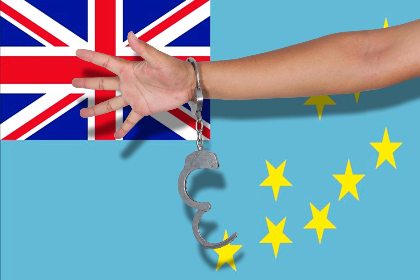 handcuffs with hand on Tuvalu flag photo