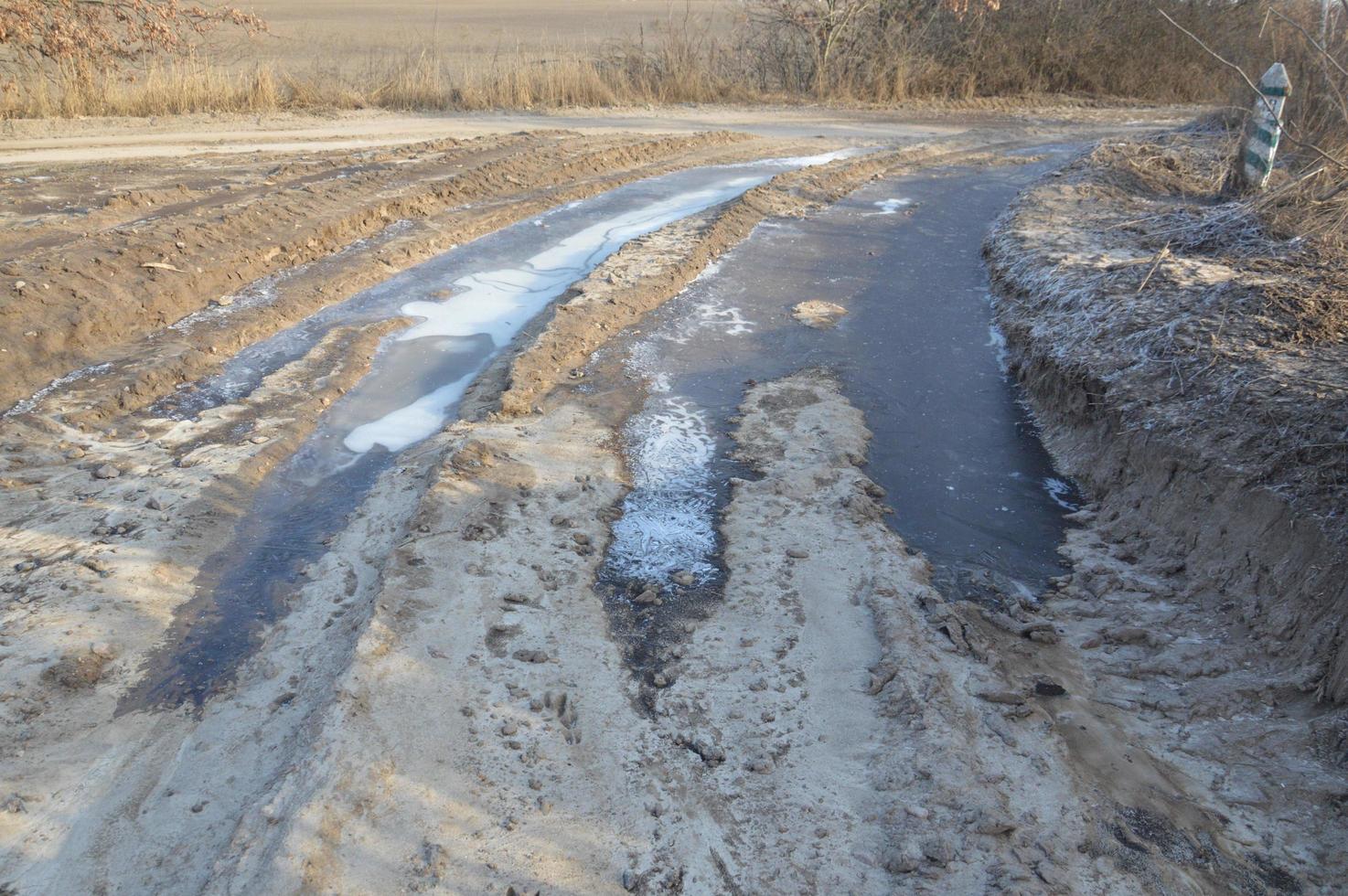 Forest frozen road with ice and snow photo