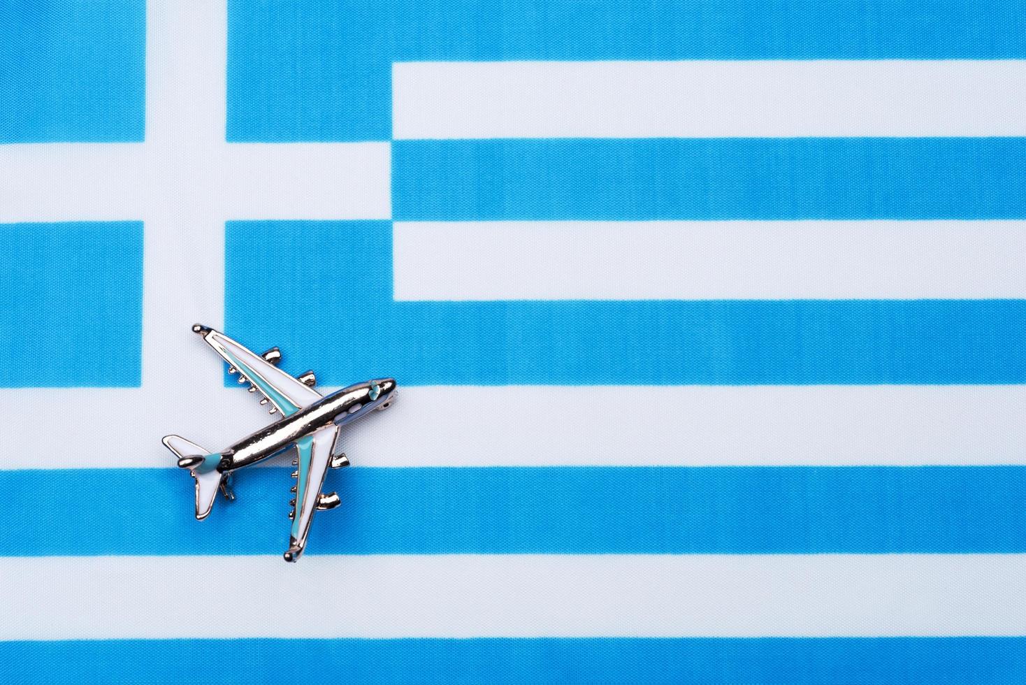 Flag of Greece and the plane. The concept of travel. photo