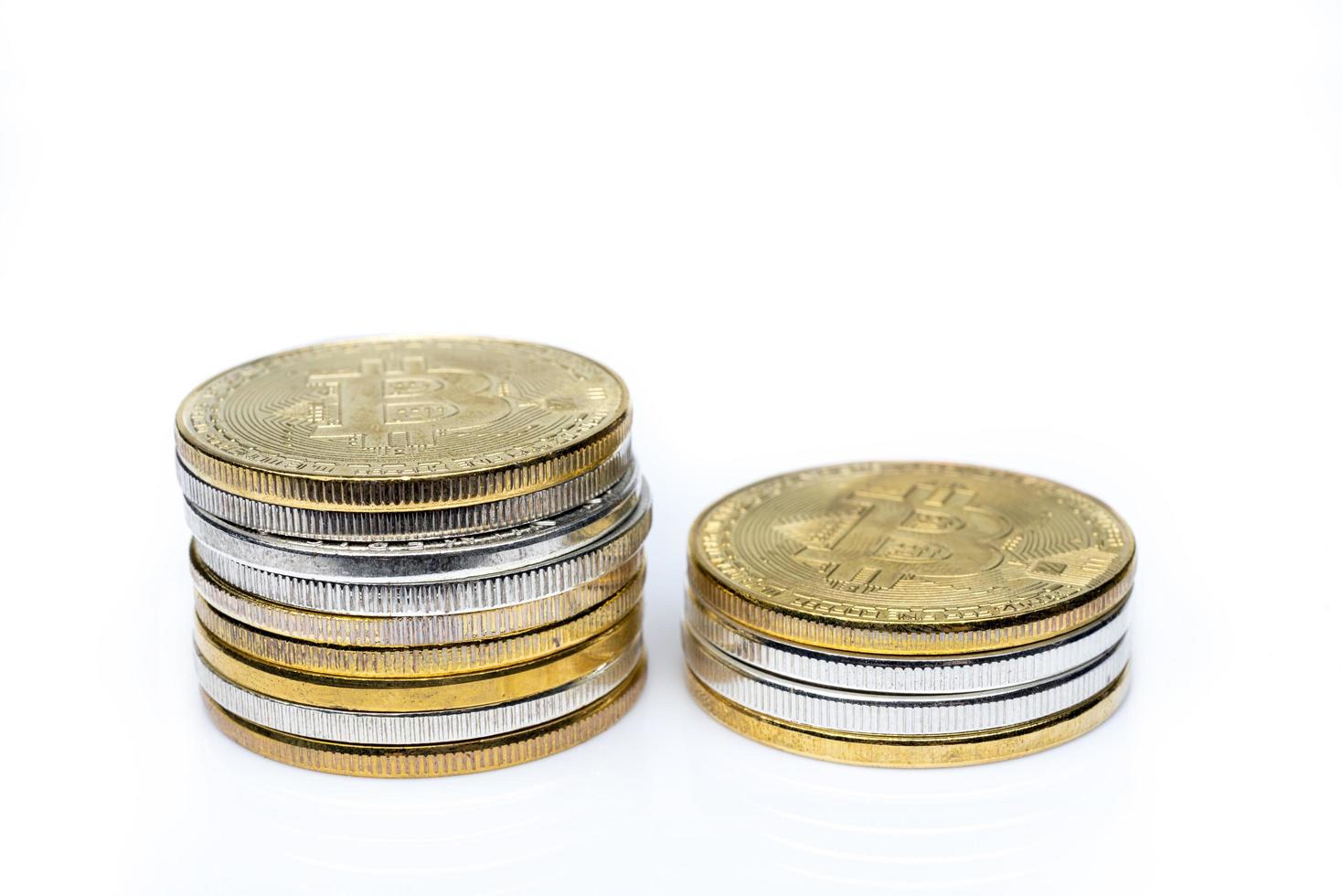 Two stacks of bitcoins on a white background. photo