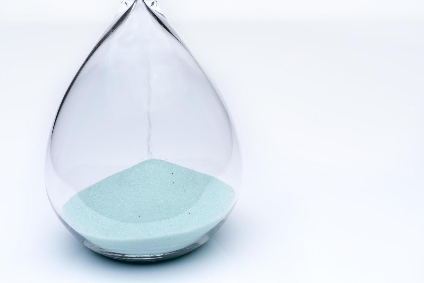 Hourglass on white background. Sand falls inside the flask. photo