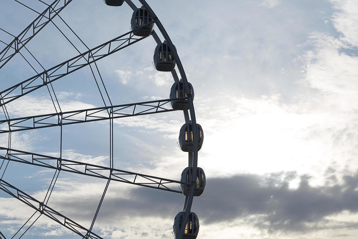 Big Ferris Wheel on clear blue sky background, close up photo