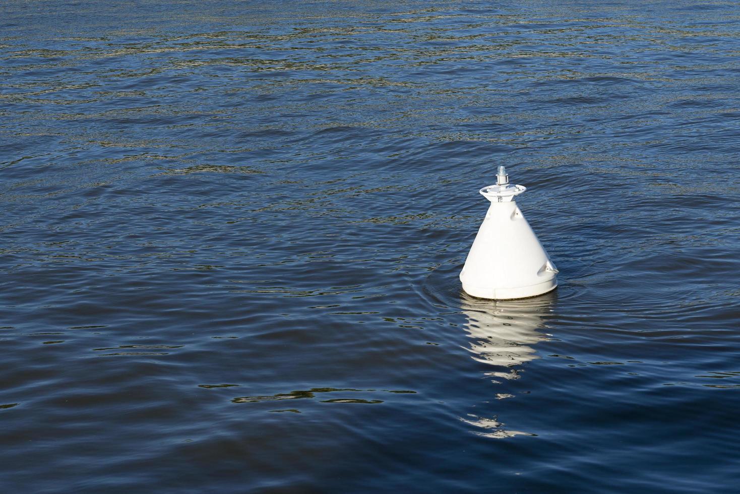 The white buoys in the dark blue water. photo