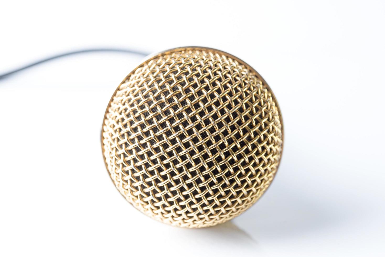 Microphone on a white background with a gold-plated nozzle. photo