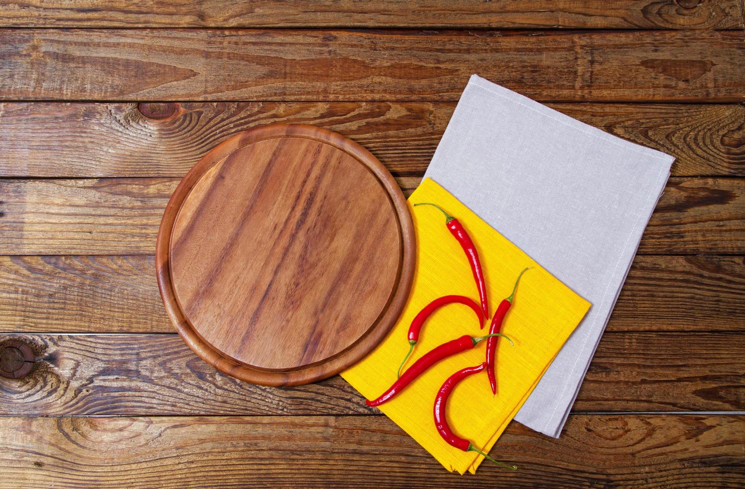 wooden table, desk for pizza, hot chili pepper with coloured napkins. Holiday concept photo